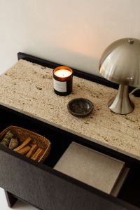 Kaboompics - Black Console Detail with Travertine Top, Dome Lamp and Lit Candle
