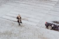Kaboompics - Snowy Street with Cars & woman walking along a sidewalk