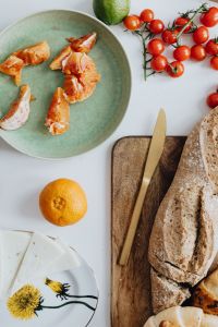 Kaboompics - Overhead Arrangement of Bread, Cheese, Tomatoes and Citrus