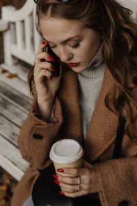 Kaboompics - Woman Talking on Phone with Coffee on an Autumn Park Bench