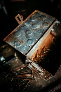 Kaboompics - Weathered Metal Box Lid With Rust and Pressed Circles