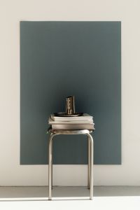 Kaboompics - Stack of Books and Chrome Vase on Stool
