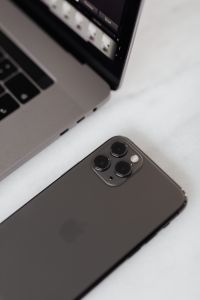 Kaboompics - MacBook Pro 15 laptop and iPhone 11 Pro on a marble table