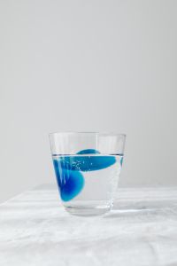 Kaboompics - Vertical Glass of Sparkling Water with Blue Accents, Minimal Drink Background