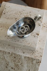 Kaboompics - Silver Spiral Earrings in a Metal Bowl