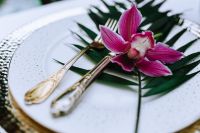 Kaboompics - Cymbidium Orchid on White Plate with Silver Cutlery, Tropical Table Styling