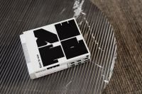 Kaboompics - Open Design Book on a Black Fluted Coffee Table with a Neutral Rug