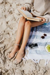 Kaboompics - Woman Reading a Book on a Beach Blanket, Summer Lifestyle