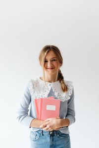 Kaboompics - Teenage Girl Holding Pink School Notebooks