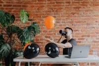 Kaboompics - Photographer Taking Pictures at Halloween Desk with Laptop and Balloons