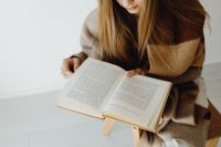 Kaboompics - Woman Reading a Book in a Wooden Chair