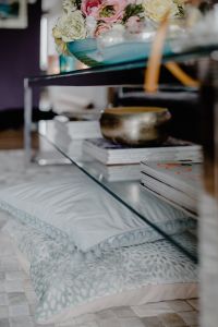 Kaboompics - Magazines and White Flowers beneath a Glass Coffee Table in a Cozy Living Room