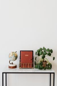 Kaboompics - Planner and Globe on Marble Console with White Copy Space