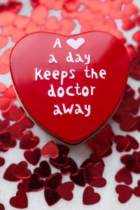 Kaboompics - Red Heart Candy with Love Message on Confetti Background