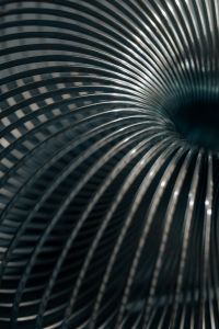 Kaboompics - Silver Spring Coil Arc on a Dark Background