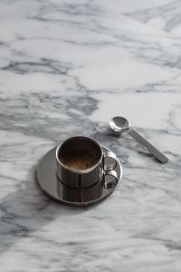 Kaboompics - Chrome Coffee Cup and Spoon Close-Up on Arabescato Marble