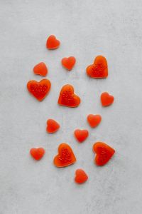 Kaboompics - Scattered Red Heart Candies on Gray Concrete