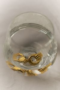 Kaboompics - Gold Earrings in Glass of Water