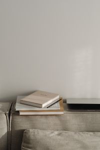 Kaboompics - Soft Neutral Home Office Background with Closed Laptop and Planner on Sofa