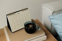 Kaboompics - January 2027 Calendar and Green Tea on Bedside Books