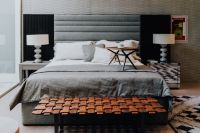 Kaboompics - Modern Bedroom with Textured Headboard, Layered Bedding and Wood Bench