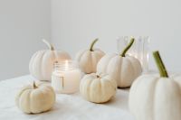 Kaboompics - White Mini Pumpkins and Candle on a Minimal Autumn Table