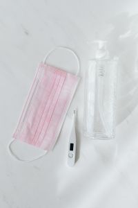 Kaboompics - Pink Face Mask with Thermometer and Clear Pump Bottle