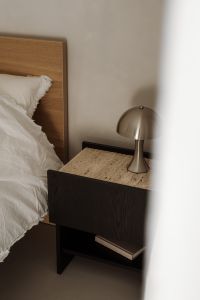 Kaboompics - White Bedding and Metallic Lamp against Neutral Wall, Bedroom Copy Space