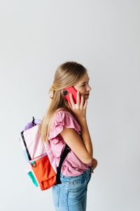 Kaboompics - Schoolgirl Talking on Phone with Backpack