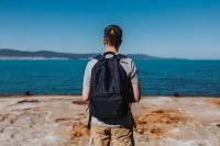 Kaboompics - Man Looking Across the Blue Sea from a Rocky Coast
