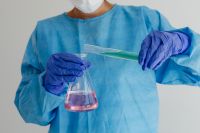 Kaboompics - Scientist Measuring Green Solution Into a Conical Flask