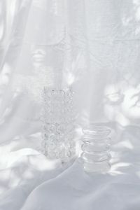 Kaboompics - Empty Bubble Glass Vases in a Minimal White Fabric Setting