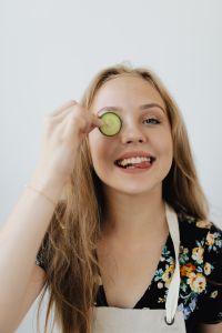 Kaboompics - Close-Up Portrait with Cucumber Slice and Playful Expression