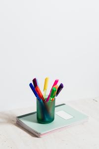 Kaboompics - Colorful Markers on a Mint Notebook, School Desk Supplies for Notes and Study Planning