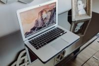Kaboompics - Silver Apple MacBook Pro on a shiny table
