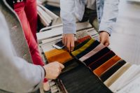 Kaboompics - Hands Comparing Colorful Upholstery Fabric Samples in a Furniture Showroom