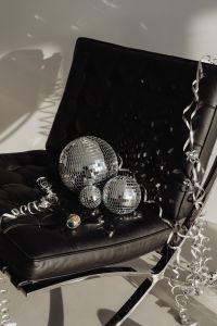 Kaboompics - Close-Up Disco Balls and Silver Streamer on a Black Leather Chair