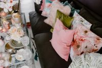 Kaboompics - Porcelain, glass dishware on the glass table and pillows