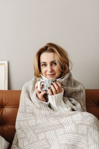 Kaboompics - Stay-at-Home Comfort: Woman Holding a Mug of Tea