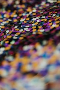 Kaboompics - Purple, Gold and Blue Sequins in Diagonal Folds, Multicolor Fabric Macro Background