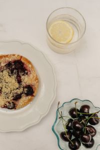 Kaboompics - Cherry Pastry, Fresh Cherries and Lemon Water on a Table