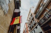 Kaboompics - Spanish Flag Hanging Above a Narrow Madrid Street