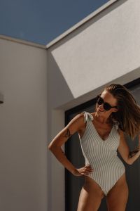 Kaboompics - Smiling Woman in Striped Swimsuit and Sunglasses in Sunlight