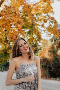 Kaboompics - Playful Champagne Portrait in Silver Sequins among Autumn Leaves