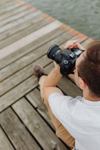 Kaboompics - Photographer holding a DSLR camera