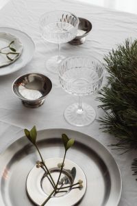 Kaboompics - Overhead Holiday Table with Evergreen Wreath, Lit Candles and Silver Place Settings