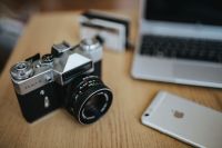 Kaboompics - Old Zenit Camera with iPhone and Laptop on Wooden Desk