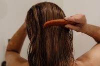 Kaboompics - Close-Up of a Comb Through Wet Hair