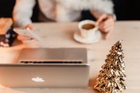 Kaboompics - Laptop in Foreground with Coffee Cup and Gold Christmas Tree