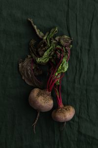 Kaboompics - Fresh Beetroot With Leaves on Dark Green Fabric
